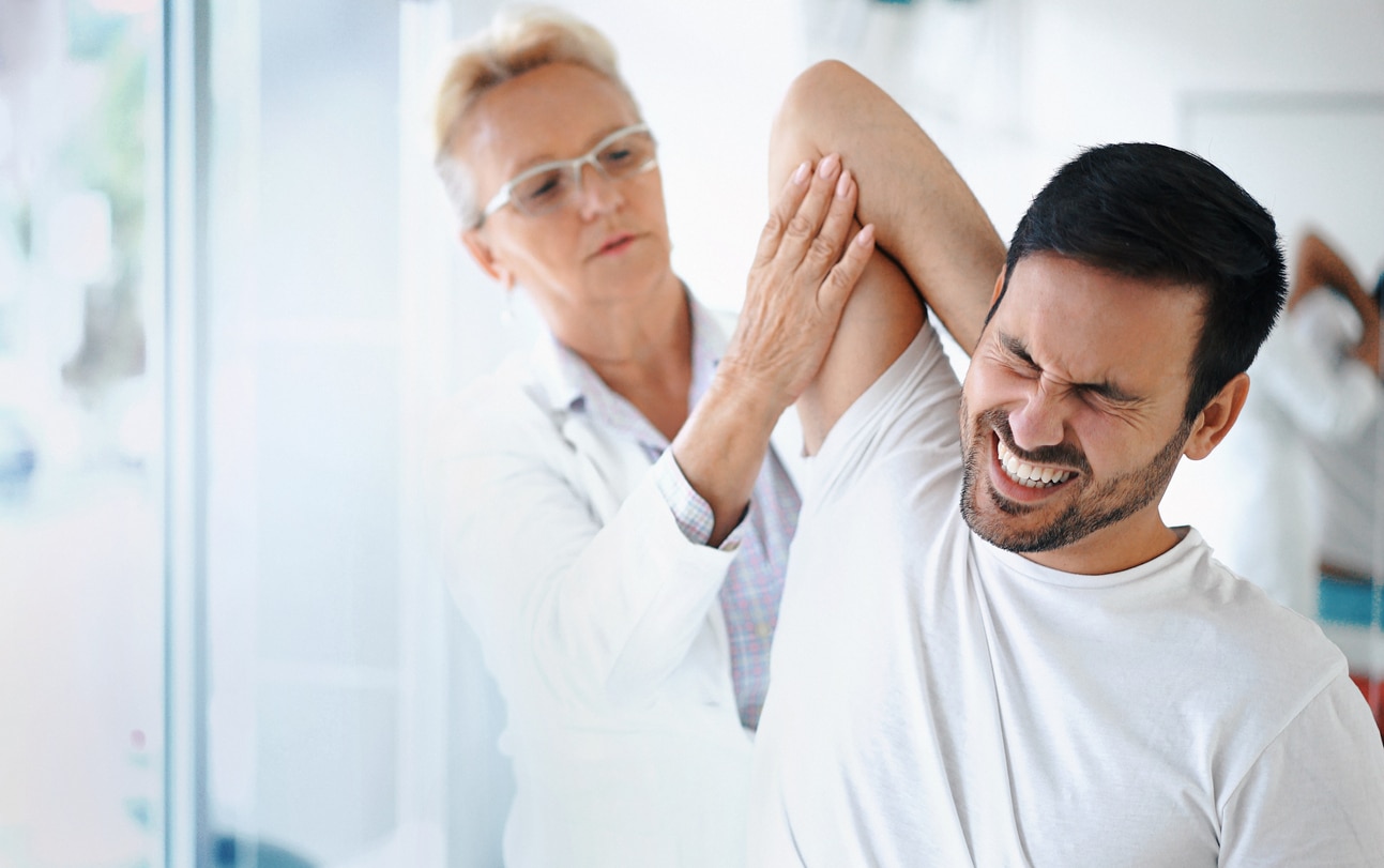 Provider examining a man's painful shoulder Provider examining a man's painful shoulder