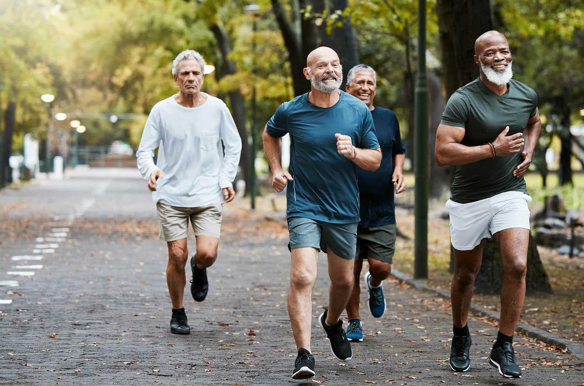 Senior, man group and running on street together for elderly fitness and urban wellness with happiness. Happy retirement, smile and runner club in workout, diversity and teamwork in park for health Aesthetic Enhancement at Winter Park Regenerative Medicine
